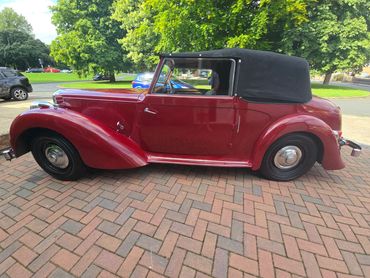 Passenger side of red Alvis TA14 showing polish and tyre shine