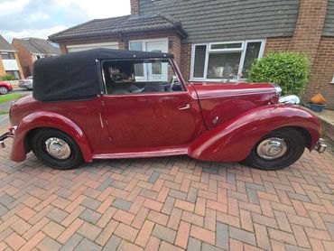 Driver side of red Alvis TA14 showing gloss and clean finish