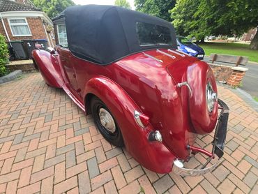 Rear 3/4 of red Alvis TA14 showing paintwork symmetry after detail