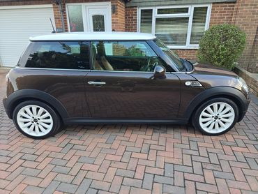 Driver side of brown Mini Cooper showing gloss and clean finish