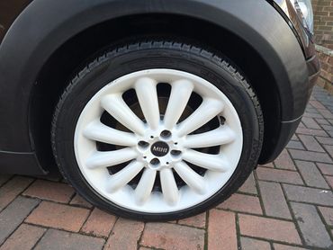 Wheel and caliper of brown Mini Cooper Evoque cleaned by AM Auto Aesthetics