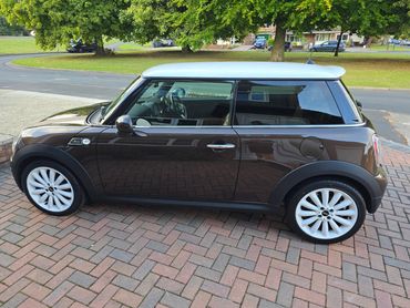 Passenger side of brown Mini Cooper showing polish and tyre shine