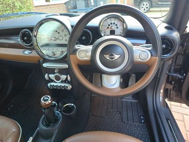 Interior of brown Mini Cooper from driver’s view after interior valet