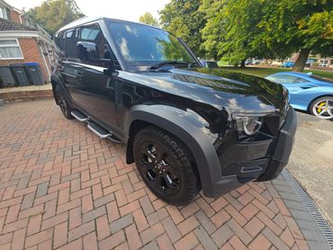 Front 3/4 of black Range Rover Defender with restored shine after valet by AM Auto Aesthetics