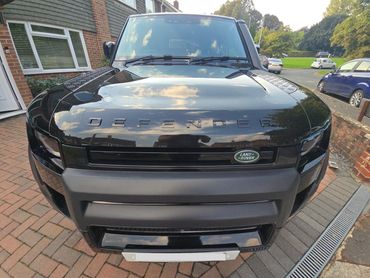 Front of black Range Rover Defender showing gloss after polish by AM Auto Aesthetics