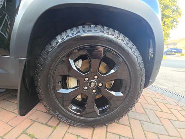 Wheel and caliper of black Range Rover Defender cleaned by AM Auto Aesthetics