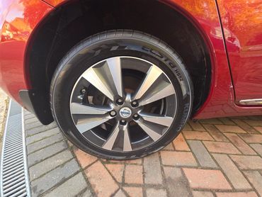 Wheel and caliper of red Nissan Leaf cleaned by AM Auto Aesthetics