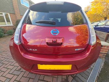 Rear of red Nissan Leaf with boot gloss and clean exhaust finish