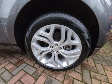 Front wheel and caliper of grey Range Rover Evoque cleaned by AM Auto Aesthetics