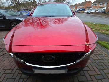 Front of red Mazda CX-5 showing gloss after polish by AM Auto Aesthetics