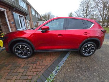 Passenger side of red Mazda CX-5 showing polish and tyre shine