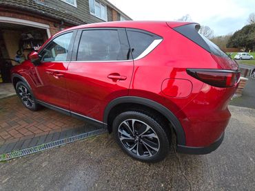 Rear 3/4 of red Mazda CX-5 showing paintwork symmetry after detail