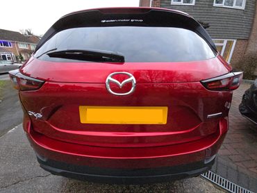 Rear of red Mazda CX-5 with boot gloss and clean exhaust finish