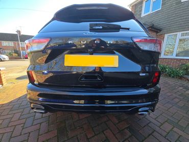 Rear of black Ford Kuga with boot gloss and clean exhaust finish