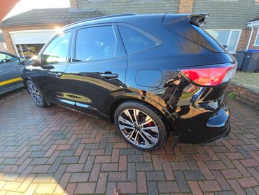 Rear 3/4 of black Ford Kuga showing paintwork symmetry after detail