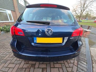 Rear of blue Vauxhall Astra with boot gloss and clean exhaust finish
