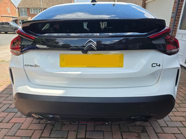 Rear of white Citroen C4 with boot gloss and clean exhaust finish