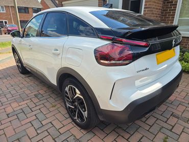 Rear 3/4 of white Citroen C4 showing paintwork symmetry after detail