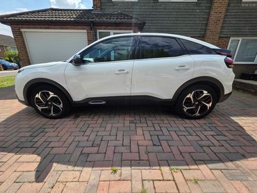 Passenger side of white Citroen C4 showing polish and tyre shine