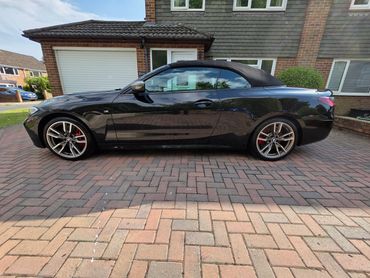 Passenger side view of BMW after full Revive including machine polish, highlighting the panel gloss