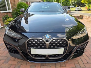 Bonnet and front end of black BMW after machine polishing by AM Auto Aesthetics in Salisbury,