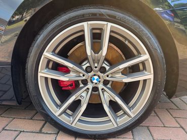 Passengers side rear alloy wheel and brake caliper on BMW, detailed by AM Auto Aesthetics