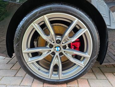 Drivers side rear alloy wheel and brake caliper on BMW, detailed by AM Auto Aesthetics