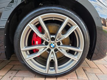 Drivers side rear alloy wheel and brake caliper on BMW, detailed by AM Auto Aesthetics