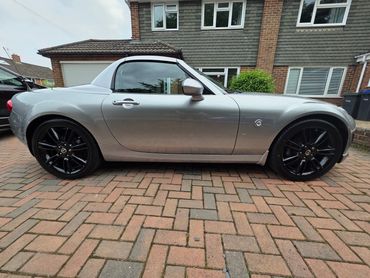 Driver side of silver Mazda MX5 showing gloss and clean finish