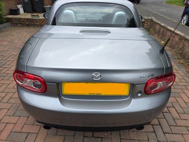 Rear top view of silver Mazda MX5 with boot gloss and clean exhaust finish