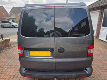 Rear doors of grey VW Camper Van with boot gloss and clean exhaust finish