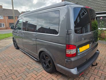 Rear 3/4 of grey VW Camper Van showing paintwork symmetry after detail