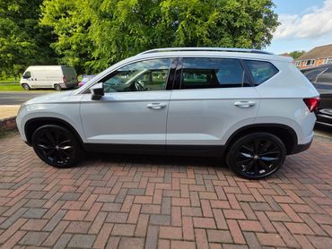 Passenger side of white Seat Ateca showing polish and tyre shine