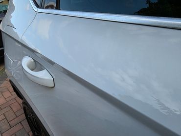 Close up of passenger door on white Seat Ateca showing glossy swirl free shine