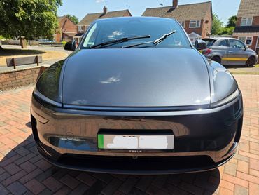 Front of Tesla Model Y showing gloss after polish by AM Auto Aesthetics