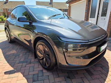 Front 3/4 of Tesla Model Y with restored shine after valet by AM Auto Aesthetics