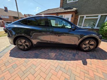 Driver side of Tesla Model Y showing gloss and clean finish