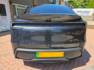 Rear of Tesla Model Y with boot gloss and clean exhaust finish