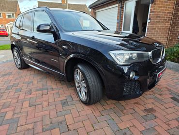 Front 3/4 of blue BMW X3 with restored shine after valet by AM Auto Aesthetics