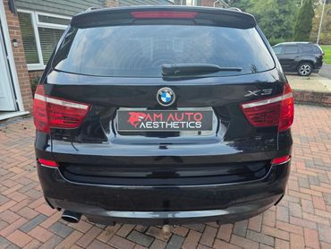 Rear of blue BMW X3 with boot gloss and clean exhaust finish