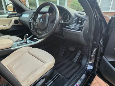 Interior of blue BMW X3 from driver’s view after interior valet