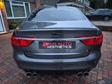 Rear view of a grey Jaguar XF with AM Auto Aesthetics branding.