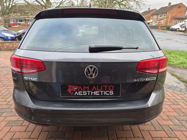 Rear view of a gray Volkswagen Passat 2.0 TDI with AM Auto Aesthetics plate.