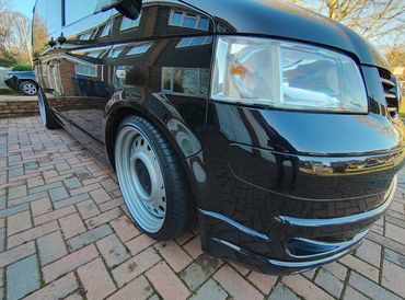 Lower front 3/4 of black VW Transporter with restored shine after valet by AM Auto Aesthetics