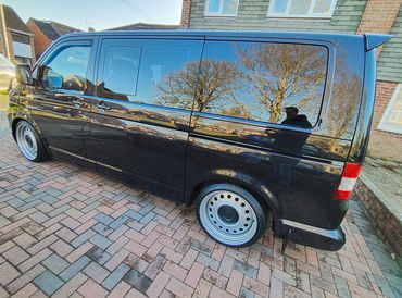 Rear 3/4 of black VW Transporter showing paintwork symmetry after detail