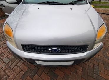 Front of silver Ford Fusion showing gloss after polish by AM Auto Aesthetics