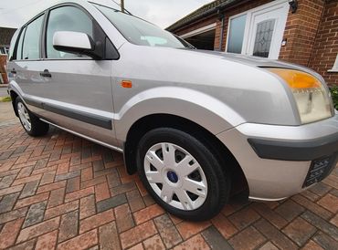 Front 3/4 of silver Ford Fusion with restored shine after valet by AM Auto Aesthetics