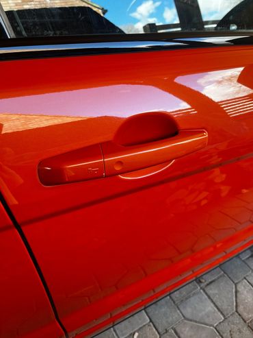 Close up drivers side door orange Range Rover Evoque polished and detailed by AM Auto Aesthetics