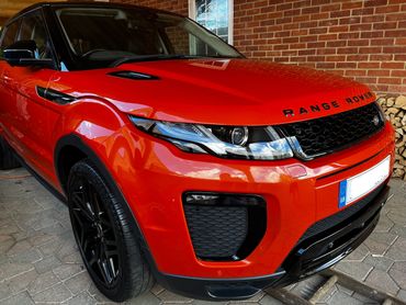 Front 3/4 of orange Range Rover Evoque with restored shine after valet by AM Auto Aesthetics