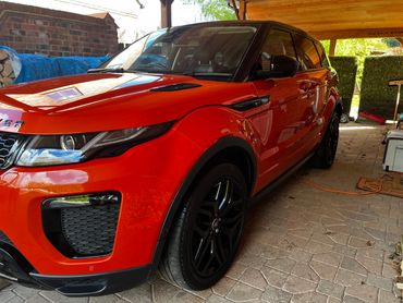 Front 3/4 of orange Range Rover Evoque polished to gloss by AM Auto Aesthetics